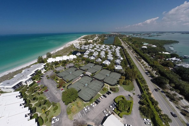 birds eye view of property featuring a beach view and a water view