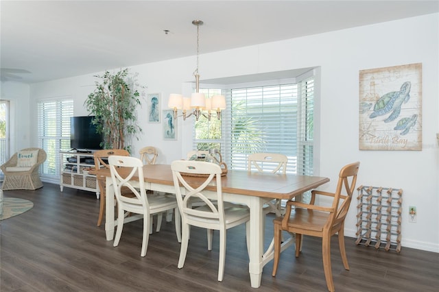 dining room featuring a chandelier and dark wood-type flooring