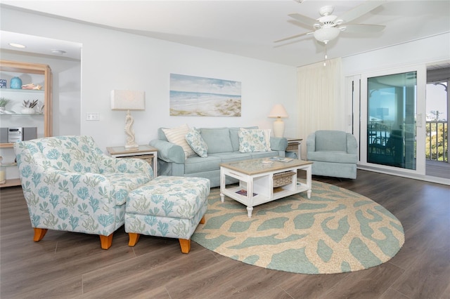 living room featuring ceiling fan and dark wood-type flooring