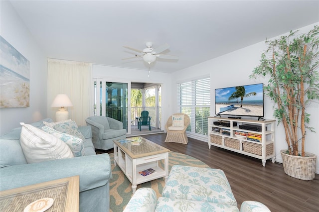 living room with dark hardwood / wood-style flooring and ceiling fan