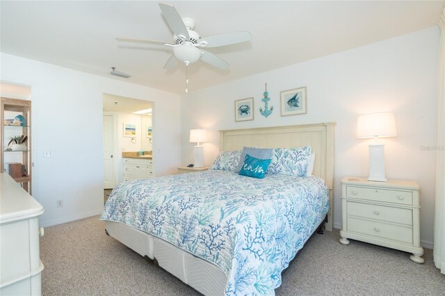 bedroom featuring light colored carpet, connected bathroom, and ceiling fan