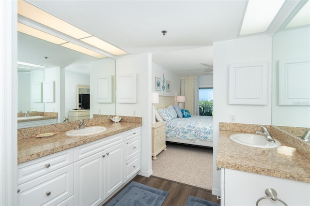 bathroom with hardwood / wood-style flooring and dual vanity