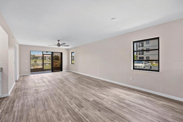 unfurnished living room with ceiling fan and light hardwood / wood-style floors