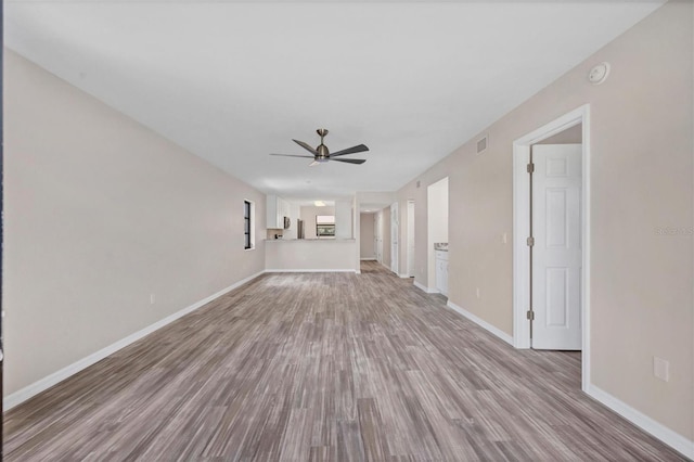 unfurnished living room with wood-type flooring and ceiling fan