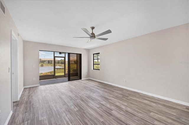 spare room featuring hardwood / wood-style flooring and ceiling fan