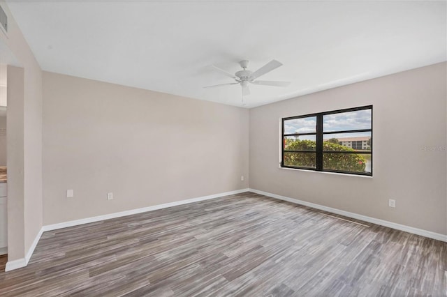 empty room featuring wood-type flooring and ceiling fan