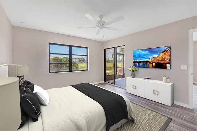 bedroom featuring ceiling fan, light hardwood / wood-style flooring, and access to outside