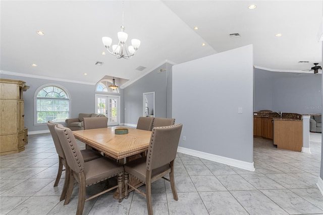 dining room with french doors, ceiling fan with notable chandelier, vaulted ceiling, and ornamental molding