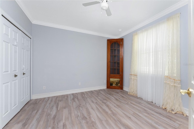 unfurnished bedroom featuring ceiling fan, a closet, light hardwood / wood-style floors, and ornamental molding