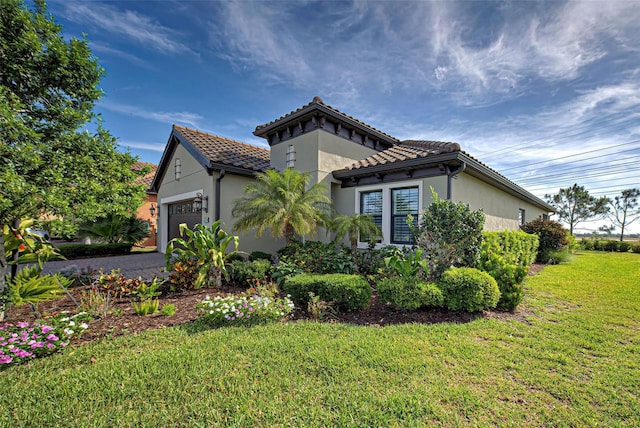 view of side of home featuring a garage and a yard