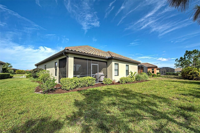 rear view of property with a lawn