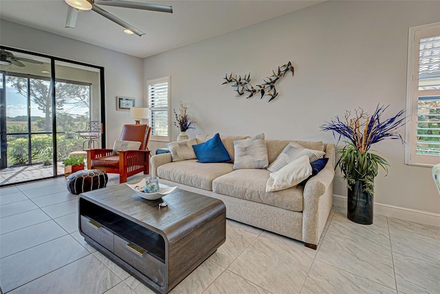 living room featuring plenty of natural light, ceiling fan, and light tile floors