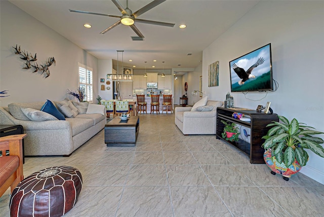 tiled living room featuring ceiling fan