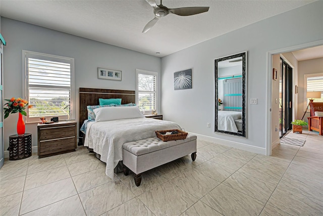 bedroom featuring ceiling fan and light tile flooring