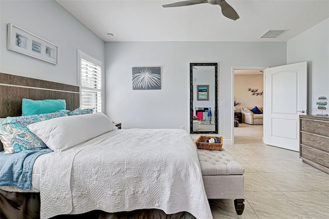 tiled bedroom with ceiling fan