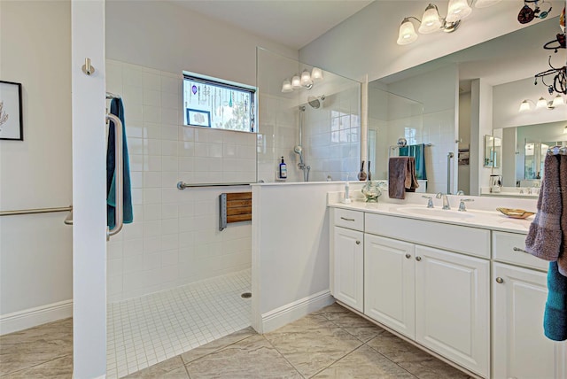 bathroom featuring vanity, a tile shower, and tile floors