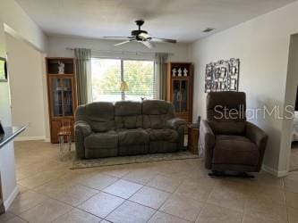 living room featuring ceiling fan and light tile patterned floors