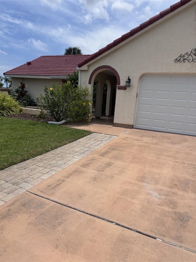 mediterranean / spanish-style house featuring a garage