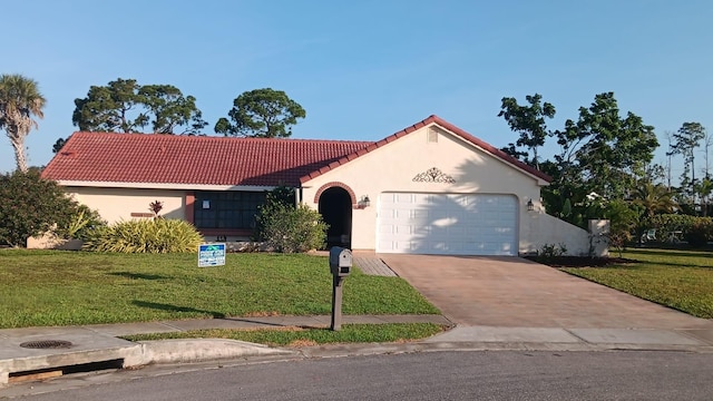 mediterranean / spanish-style house with a front lawn and a garage