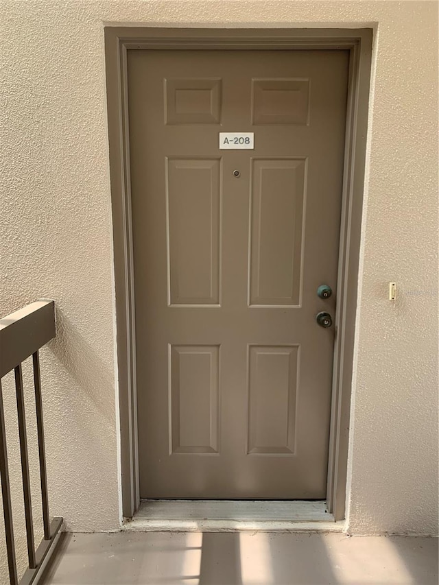 doorway to property with stucco siding