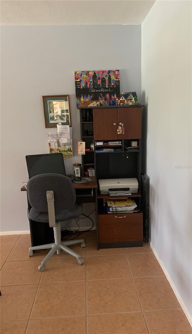 office with baseboards and light tile patterned floors