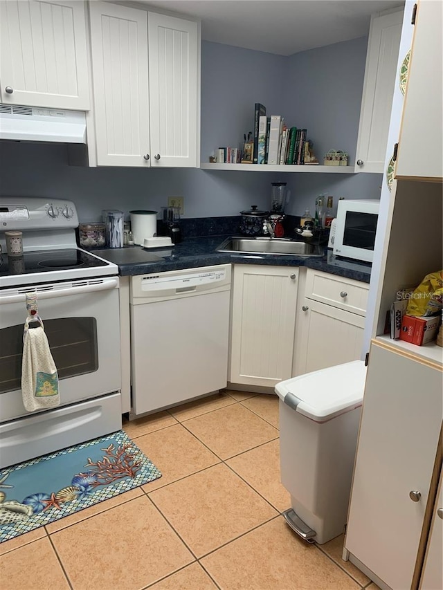 kitchen featuring white appliances, light tile patterned flooring, a sink, and open shelves