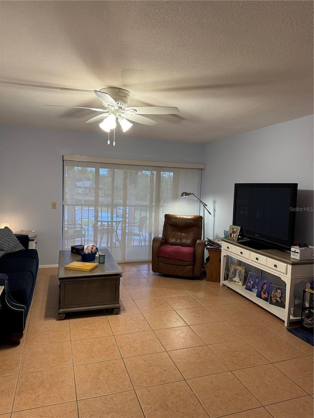 tiled living area with a ceiling fan and a textured ceiling