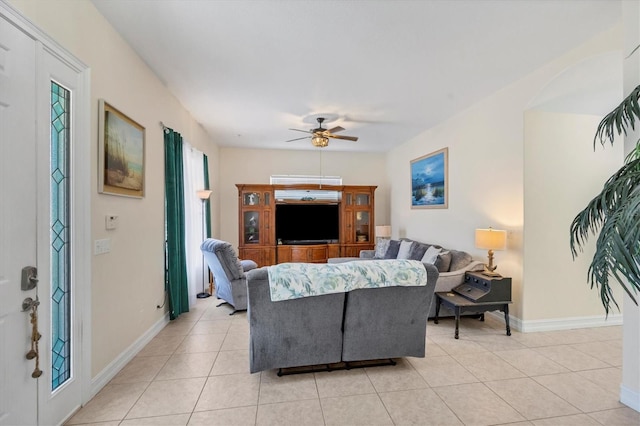 tiled living room with ceiling fan