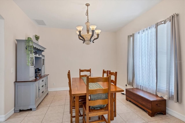 tiled dining area with a notable chandelier