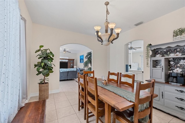 dining area with ceiling fan with notable chandelier and light tile floors