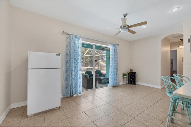 interior space with ceiling fan and light tile floors