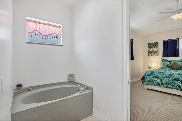 bathroom featuring a bath to relax in and ceiling fan