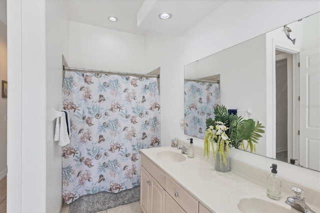 bathroom with tile flooring and dual vanity