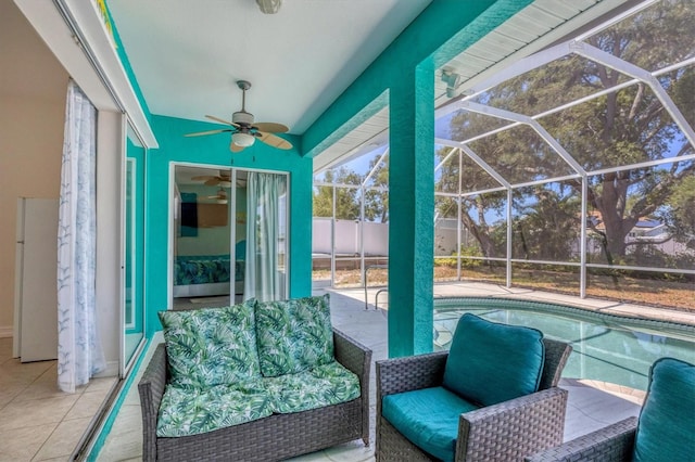 sunroom / solarium featuring ceiling fan