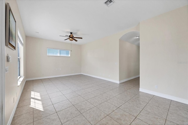 tiled spare room featuring ceiling fan