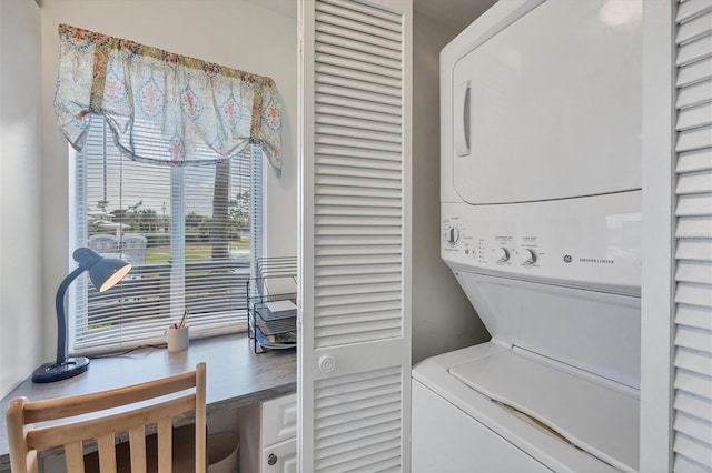 laundry room featuring stacked washer / drying machine