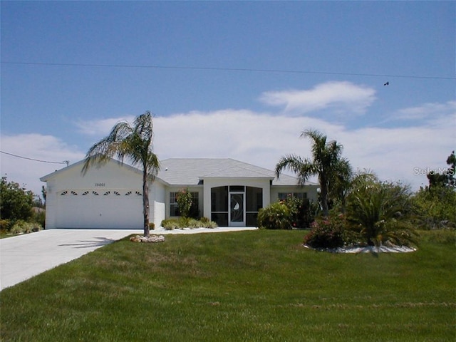 view of front of property featuring a garage and a front lawn