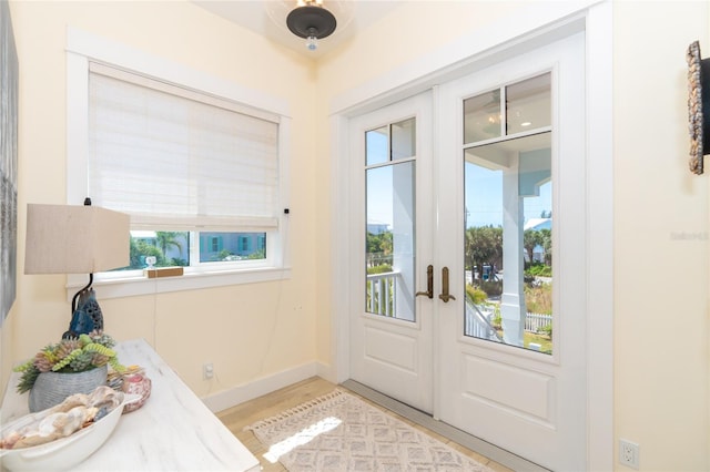 entryway featuring a wealth of natural light, light hardwood / wood-style flooring, and french doors