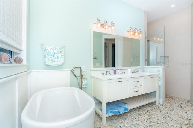 bathroom featuring tile floors, a bath to relax in, and dual vanity