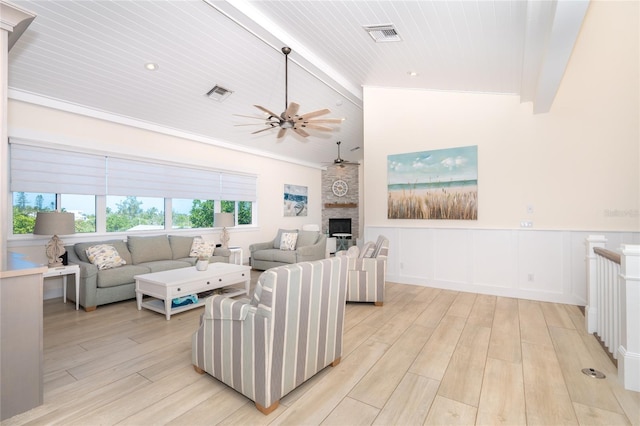 living room with lofted ceiling with beams, a fireplace, light wood-type flooring, wood ceiling, and ceiling fan