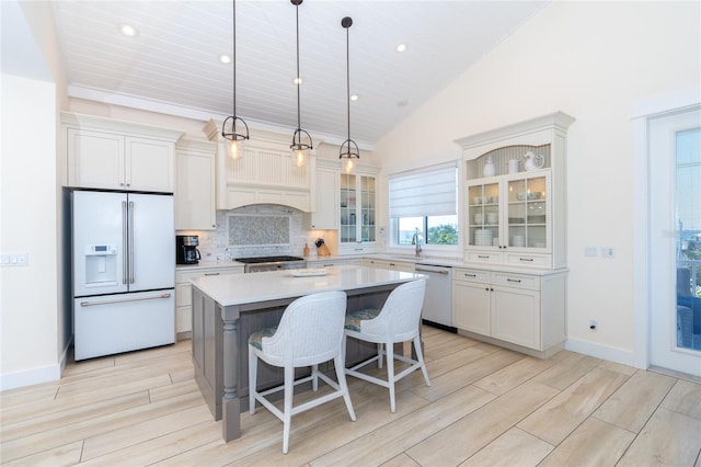 kitchen featuring dishwashing machine, a kitchen island, backsplash, hanging light fixtures, and high end white fridge