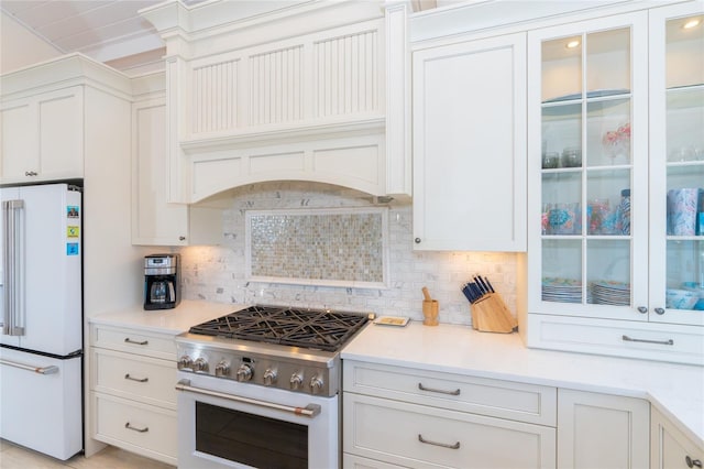 kitchen with white cabinets, white appliances, tasteful backsplash, and custom range hood