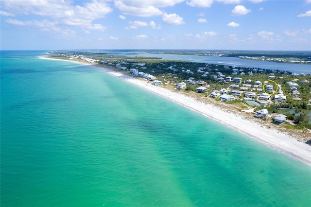 drone / aerial view with a beach view and a water view