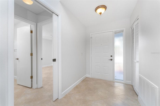 foyer entrance with a wealth of natural light and light tile floors