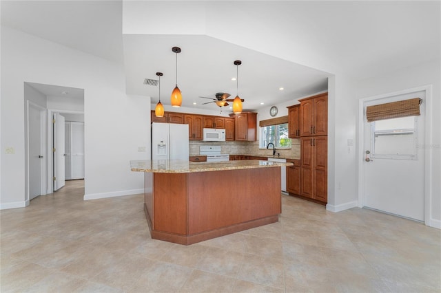 kitchen with a center island, decorative light fixtures, white appliances, tasteful backsplash, and ceiling fan