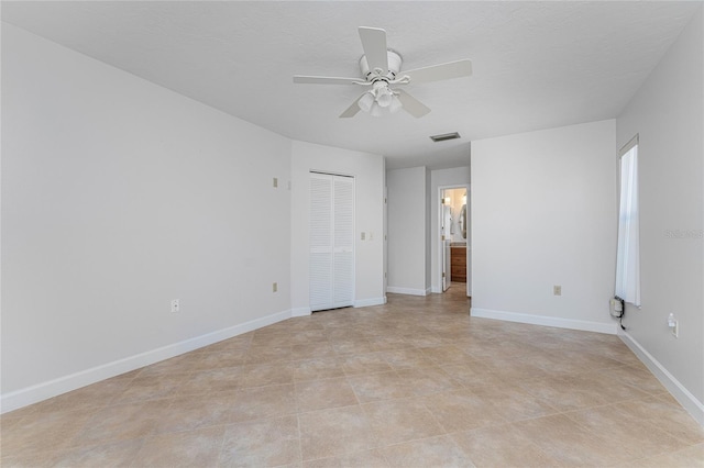 unfurnished bedroom featuring a closet, ceiling fan, and light tile flooring