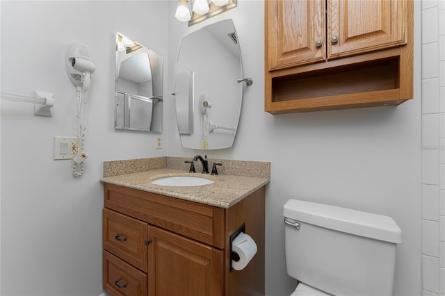 bathroom with toilet and vanity