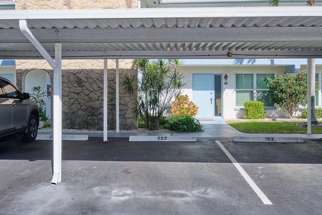 view of vehicle parking with a carport