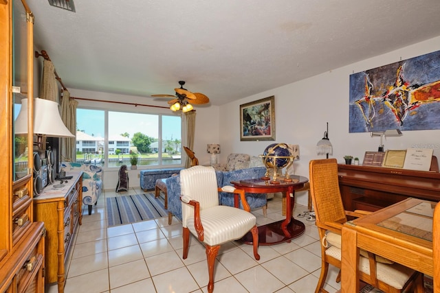 dining area with ceiling fan and light tile floors