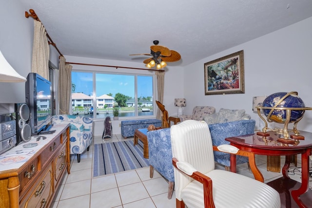 living room featuring ceiling fan and light tile flooring